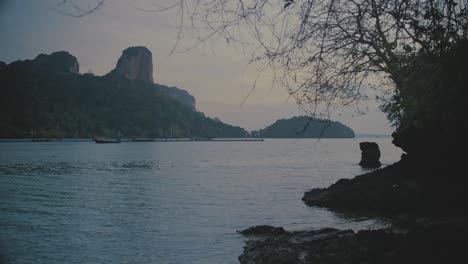 Looking-Out-At-Bay-Of-Water-In-Railway-With-Rugged-Coastline-With-Cliffs-Along-With-Fishing-Boats-Moored-In-Sea