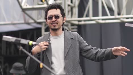 Pamungkas-passionately-performing-at-an-outdoor-concert-during-sunset