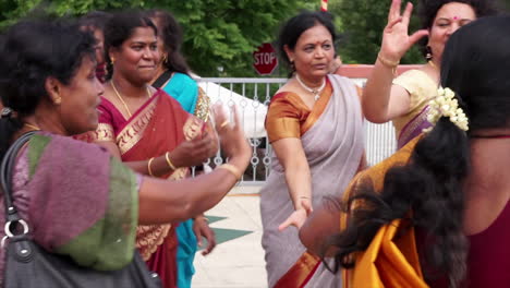 Indian-American-women-dance-around-a-Hindu-symbol