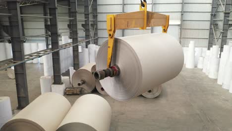 Stacking-rolls-of-paper-by-crane-inside-a-large-godown