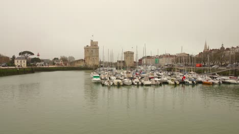 View-of-historic-Towers-of-La-Rochelle-and-harbour-in-La-Rochelle,-France-during-a-mist-day