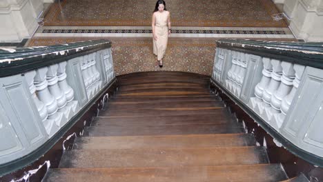 Female-Asian-model,-climbing-luxurious-stairway,-balustrade,-slow-mo