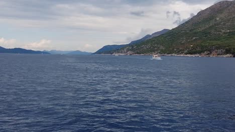 A-scene-captured-from-a-boat-floating-on-the-serene-sea-waters-of-the-Elafiti-Islands,-Croatia,-embodying-the-concept-of-peaceful-maritime-exploration-and-natural-beauty