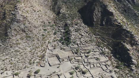 High-angle-aerial-of-archaeological-ruins-of-Ciudad-Sagrada-in-the-mountain-landscape-of-Argentina