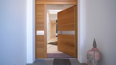 Slow-dolly-shot-of-a-hallway-revealing-from-a-villas-wooden-doorway