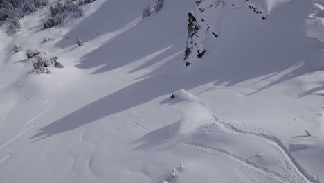 Drone-shot-of-a-Snowboarder-riding-untouched-powder-snow