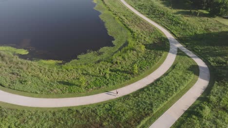 A-top-down-drone-view-of-two-women-walking-through-Exploration-Green-in-Clear-Lake,-Houston,-Texas