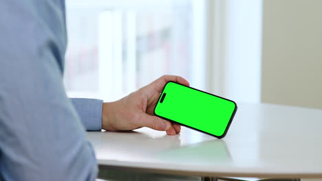 Smartphone-green-screen-template,-landscape-mode,-man-holding-phone