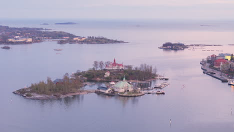 Valkosaari-island-with-wooden-pavilion-outside-Helsinki-South-Harbour,-aerial