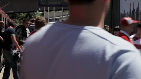 Crowded-train-station-in-Esslingen,-diverse-people-in-motion-on-sunny-day