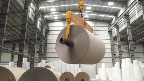 Rolls-of-paper-are-being-lowered-by-crane