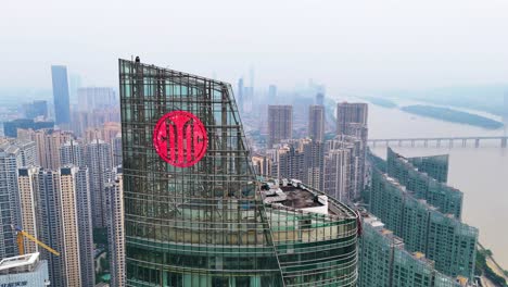 Aerial-orbiting-shot-around-a-skyscraper-in-Changsha-revealing-the-air-pollution