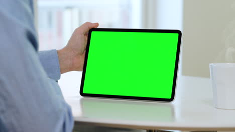 Tablet,-green-screen-template,-man-in-blue-shirt,-landscape-orientation,-coffee