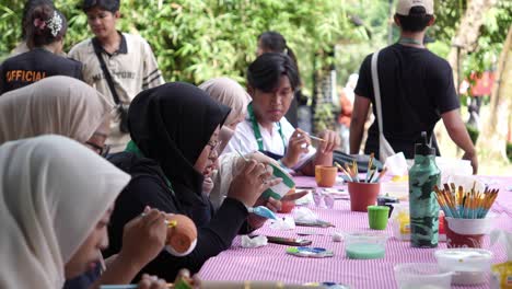 People-decorating-plant-pots-outdoors