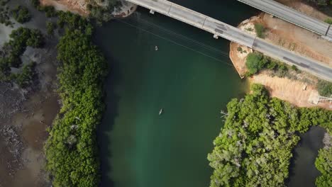 Aerial-top-down-of-boats-fishing-on-river