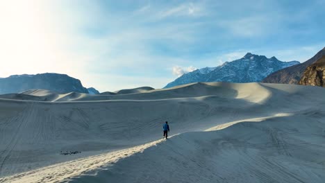 Vista-Aérea-De-Un-Hombre-Corriendo-A-Lo-Largo-De-La-Fría-Cresta-Del-Desierto-De-Sarfaranga.