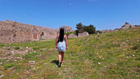 Young-european-woman-at-medieval-castle-Chlemoutsi-Castle-Clermont,-Greece