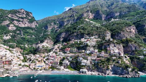 Panoramic-Aerial-Perspective:-Positano-Beach-Encircled-by-Majestic-Mountains,-Verdant-Flora,-Crystal-Clear-Waters,-and-Charming-Coastal-Homes---Amalfi-Coast,-Campania,-Italy,-Europe