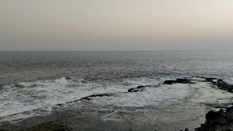 Waves-hitting-the-sea-shore-in-slow-motion-and-splashing-water