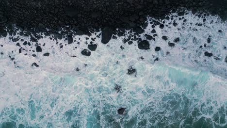 Drone-footage-of-a-black-stone-beach