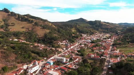 A-scenic-aerial-view-of-Delfim-Moreira,-a-picturesque-town-nestled-in-the-mountains-of-Minas-Gerais,-Brazil