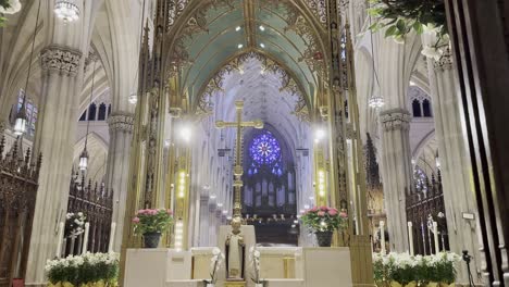 A-stunning-view-of-a-gothic-cathedral's-sanctuary,-highlighting-its-golden-altar,-intricate-details,-and-beautiful-stained-glass-windows