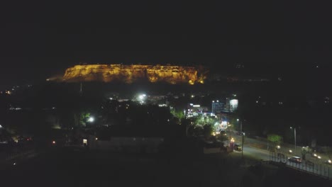 Establishing-drone-shot-of-Gwalior-city-during-night-time-with-light-traffic-on-road-in-Madhya-Pradesh-India