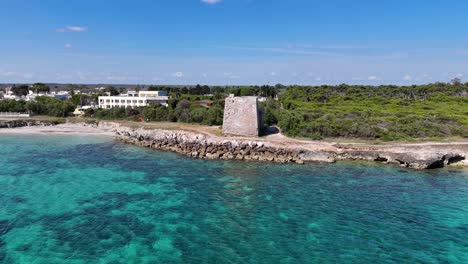 Aerial-View-Of-Torre-Specchia-Ruggeri-On-A-Beach-With-Crystal-Clear-Water-In-Puglia-Region,-Italy