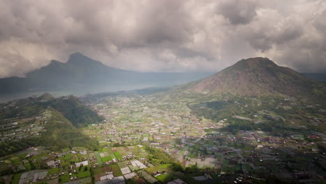 Breathtaking-view,-Mount-Batur,-farmland-landscape,-buildings,-aerial