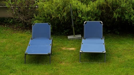 Two-Blue-Sun-Loungers-on-Lawn-on-Overcast-Day