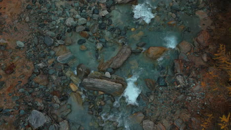 Saas-Fee-Swizerland-glacier-glacial-yellow-autumn-Larch-forest-snowmelt-Feevispa-river-aerial-drone-moody-rainy-fog-mist-cloudy-grey-peaceful-Swiss-Alpine-Alps-valley-mountain-town-birdseye-downstream