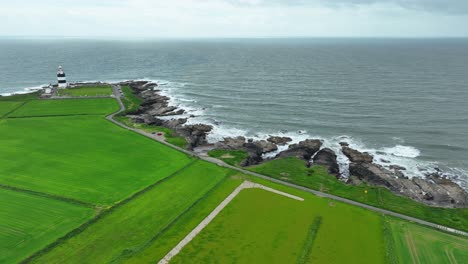 Ireland-Epic-locations-Hook-Head-Lighthouse-the-road-along-the-shore-with-rocky-inlets,-beautiful-Wexford-coastline