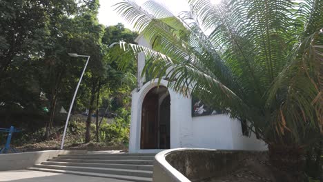 Small,-charming-white-church-surrounded-by-lush-greenery-in-Minca,-Colombia