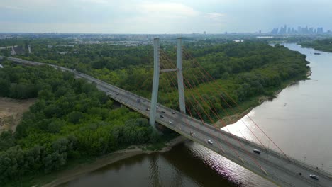 Panoramic-aerial-view,-Siekierkowski-bridge,-transportation-traffic,-nature