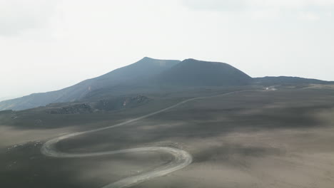 Cloud-shadows-create-speckled-pattern-of-light-on-barren-black-volcanic-landscape-in-Italy