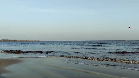 Tropical-beach-down-view-of-sea-blue-waves-break-on-sand