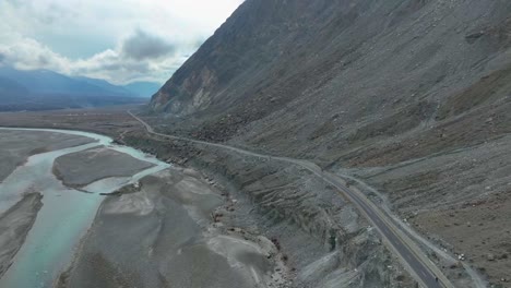 winding-river-cuts-through-the-rugged-mountains-of-Nomal-in-Gilgit-Baltistan,-showcasing-nature's-raw-beauty