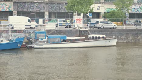 Wooden-motor-cruiser-boat-'Skorpion'-moored-along-canal-in-Vienna