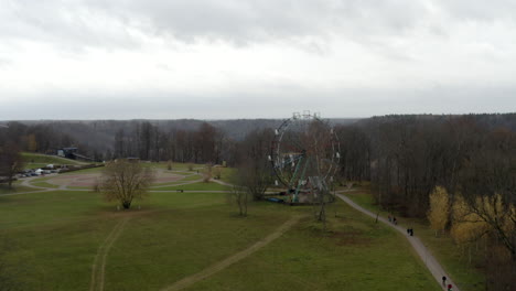 Drone-flight-above-ferris-wheel-revealing-a-valley-and-stunning-scenery