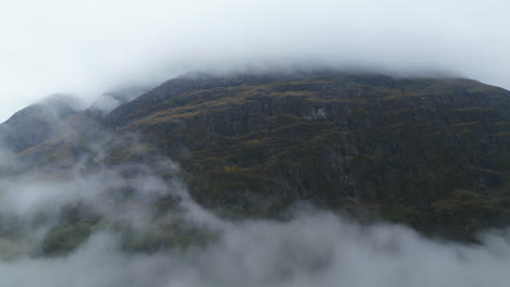 Glencoe-Mountain-Covered-in-Clouds,-Aerial-Track-with-Copy-Space