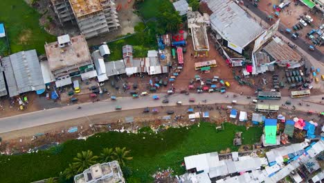 Busy-Rupatoli-market-in-Barisal,-Bangladesh,-with-bustling-traffic-and-vibrant-street-life,-aerial-view