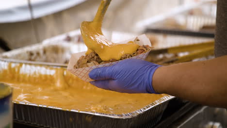 Preparing-BBQ-Cheese-Nachos-For-Sale-During-The-Dogwood-Festival-In-Siloam-Springs,-AR,-USA---Close-Up,-Slow-Motion