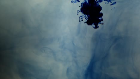 Blue-chemical-ink-contaminate-water-in-a-tank,-slow-motion