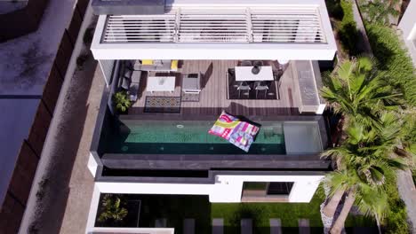 Aerial-shot-of-a-lilo-floating-on-a-balcony-private-pool-at-a-villa-in-Sete