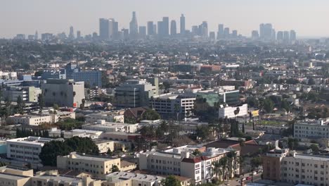 Los-Angeles,-California-city-skyline---push-in-aerial-view-on-a-smoggy-day