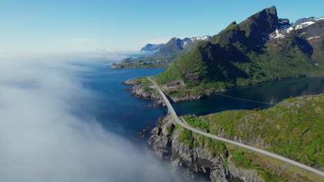 Djupfjord-Bridge-in-Moskenes,-Lofoten:-Aerial-View-among-Clouds-and-Mountains-in-Norway