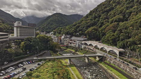 Hakone-Japan-Aerial-v1-low-flyover-along-the-Haya-river-captures-Yumoto-train-station-and-a-small-hot-springs-resort-town-nestled-in-the-mountains---Shot-with-Mavic-3-Pro-Cine---October-2023