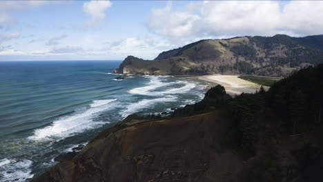 Panoramic-Coastal-Landscape-With-Forested-Hills-Overlooking-Ocean-Along-Shore,-God's-Thumb-Oregon-Coast,-Aerial-Static-View