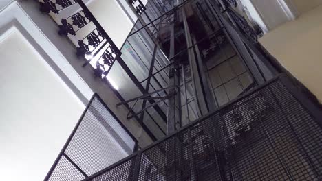 Looking-up-the-old-vintage-elevator-ascending-and-going-up-through-the-building-levels