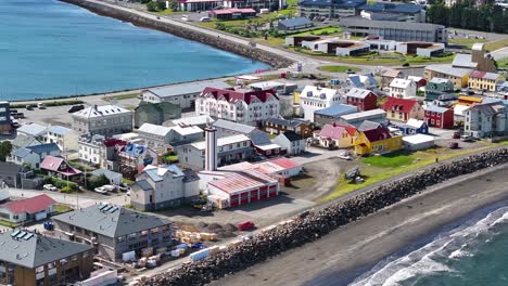 Aerial-View-of-Isafjordur-Iceland,-Buildings-and-Waterfront-on-Sunny-Day,-Drone-Shot-60fps